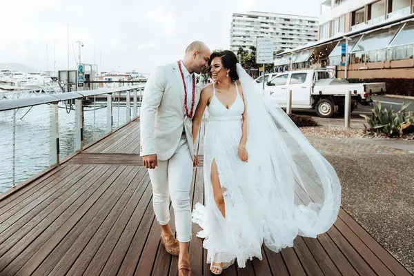 Bride and groom on a waterfront deck
