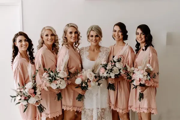 Bride with her bridesmaids in matching blush robes