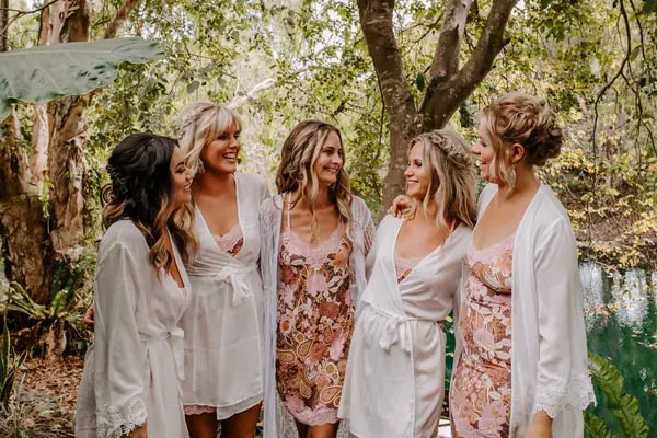 Bridesmaids in a garden holding bouquets