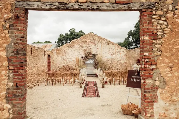 Wedding ceremony setting framed by old stone walls