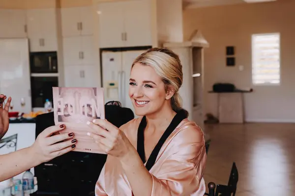 Bride in a pink robe getting ready