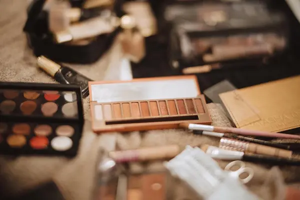 Makeup palette and brushes laid out on the wedding morning