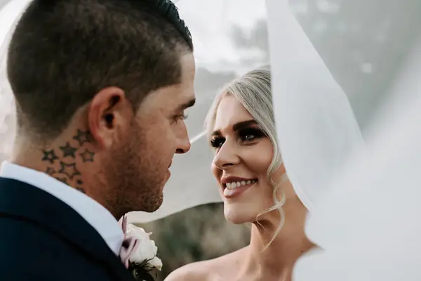 Groom kissing the bride under her veil