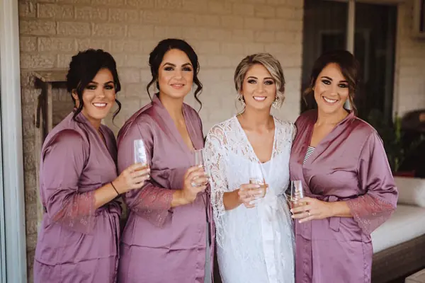Bridal party in lilac robes with the bride in white