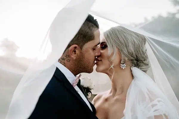 Couple sharing a moment beneath the veil