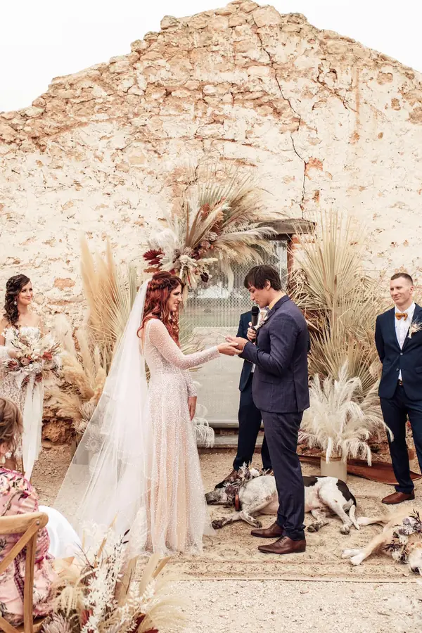 Couple exchanging vows at a boho ceremony