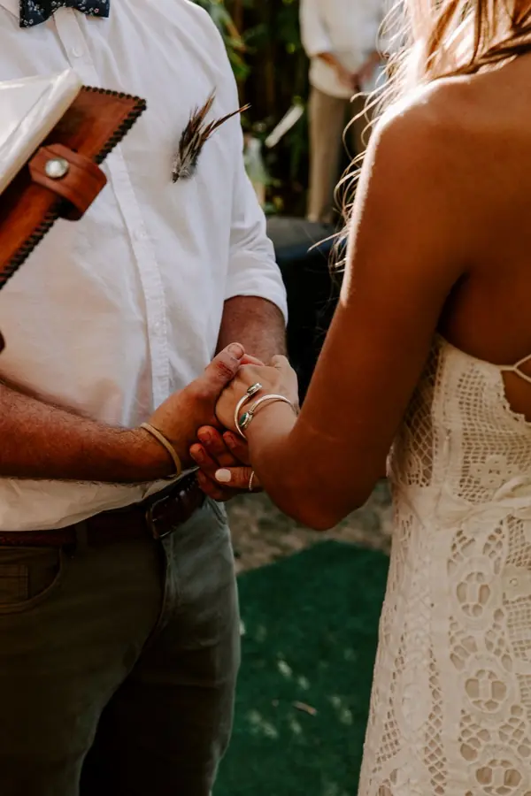 Bride holding the groom's hands during the ceremony