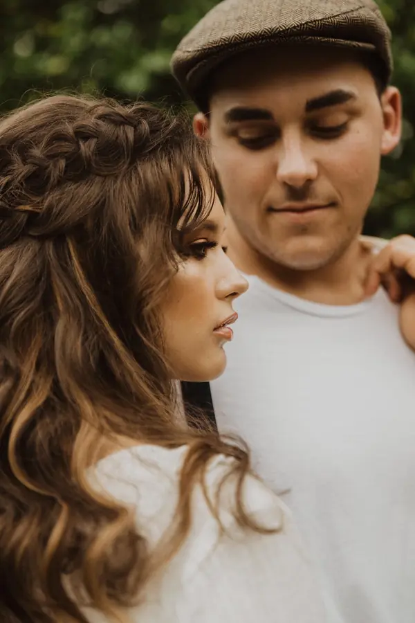 Couple in an editorial shoot, man in a flat cap
