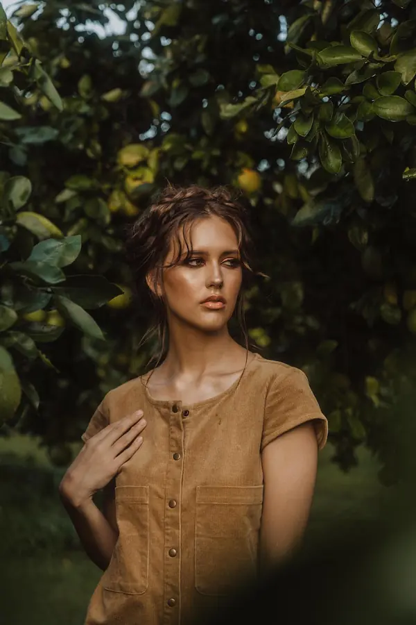 Model in a linen dress in an orchard