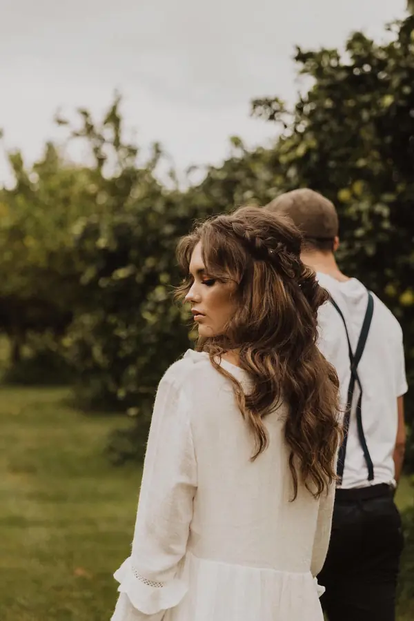 Couple walking together through an orchard