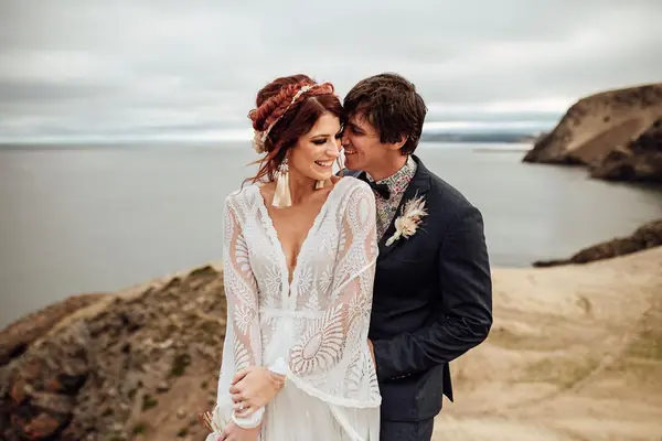 Bride and groom on a rocky Far North Queensland coastline