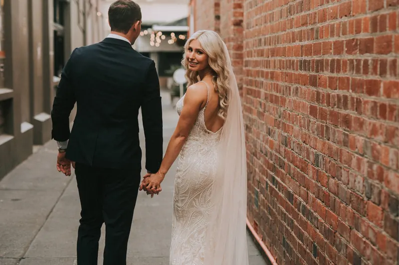 Newlyweds walking hand in hand