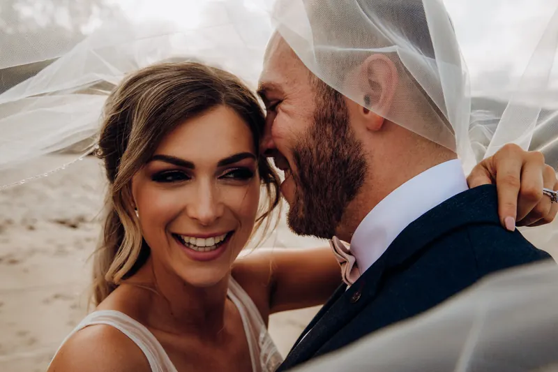 Bride laughing with her husband
